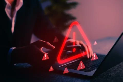 Cybersecurity alert with warning icon displayed on screen, representing dig.. Stock Photos