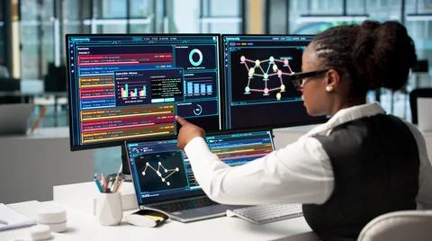 Cybersecurity Analyst Carefully Points At New Software Detecting Cyber Risks  写真素材