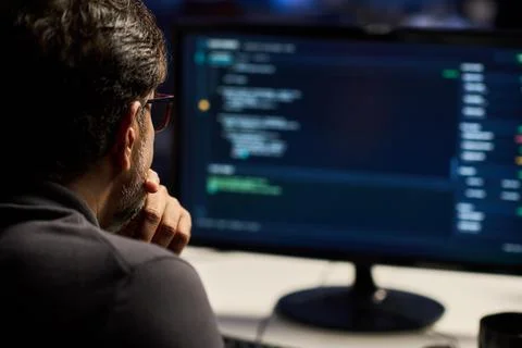 Cybersecurity Analyst Coding on Computer Screen in Office Stock Photos