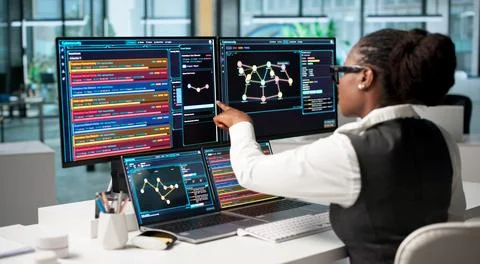 Cybersecurity Analyst Intently Pointing At New Threat Detection Software On L Stock Photos