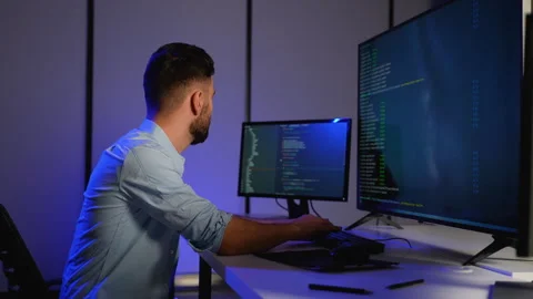 Cybersecurity analyst working on code and system monitoring Stock Footage 305008289