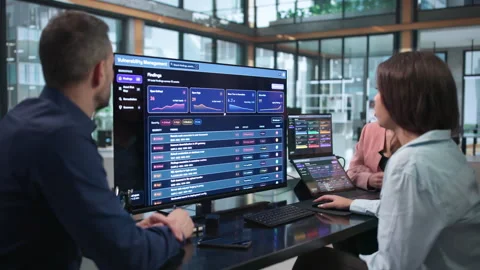 Cybersecurity Analysts Collaborate Closely Using Software To Scan Risks Stock Footage 347907289
