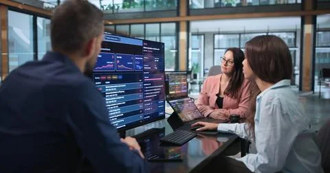 Cybersecurity Analysts Collaborate Closely Using Software To Scan Risks. Stock Photos