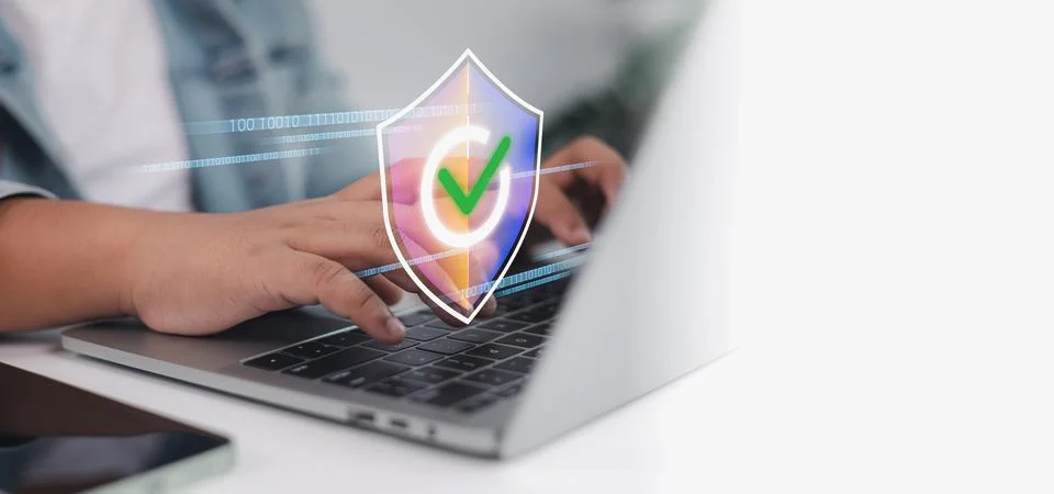 Cybersecurity and data protection  user typing on laptop with digital shiel.. Stock Photos