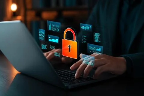 Cybersecurity concept showing hands typing on laptop with virtual lock icon.. Stock Photos