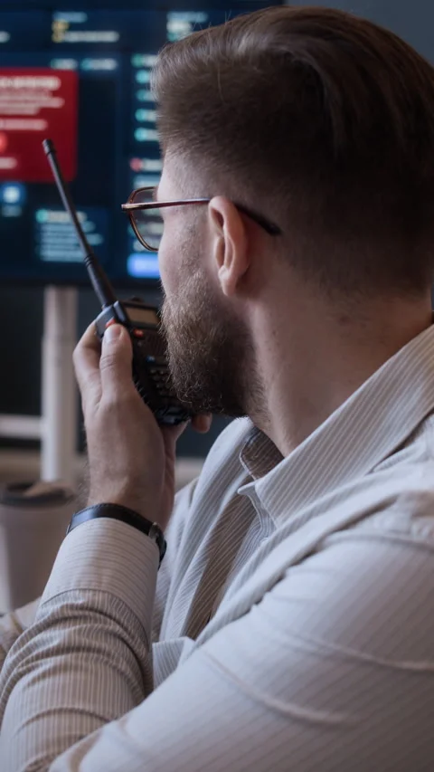 Cybersecurity Engineer Reporting about Cyberattack via Radio in Office Stock Footage 334934151