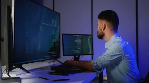 Cybersecurity expert analyzing code and monitoring system logs Stock Footage 305008483
