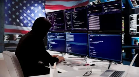 Cybersecurity Expert Coding Against The Backdrop Of The American Flag 스톡 사진