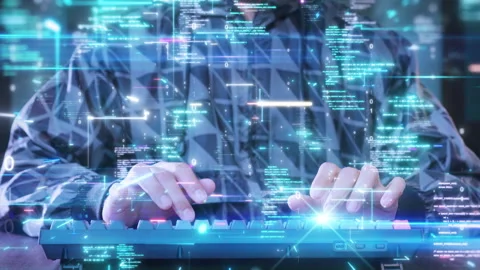 Cybersecurity expert typing on a keyboard, surrounded by floating digital codes  Stock Footage 277088379
