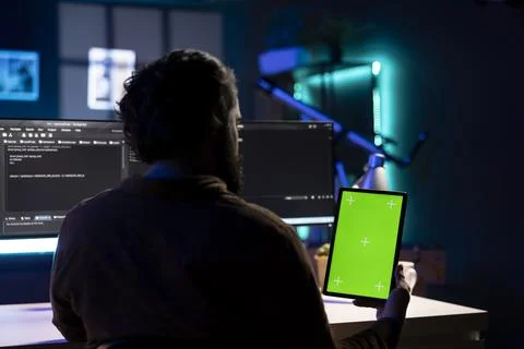 Cybersecurity expert using green screen tablet to look for malware 스톡 사진