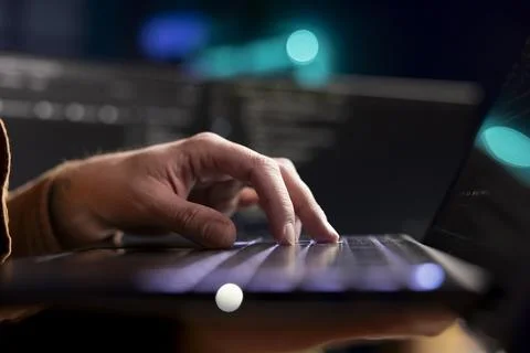 Cybersecurity expert using laptop to look for company security vulnerabilities 写真素材