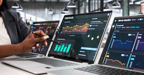Cybersecurity Experts Closely Analyze Laptop Data To Detect Network Threats. Stock Photos