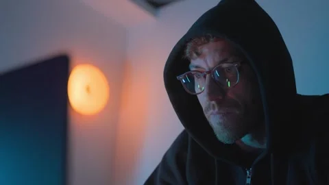 Cybersecurity hacker in hoodie using computer at night, cybercrime concept Stock Footage 327715997