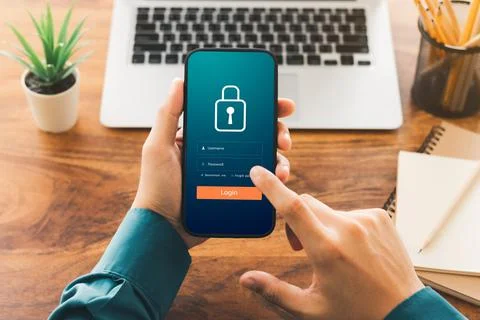 Cybersecurity internet and networking concept. Close up of hand holding smart Stock Photos