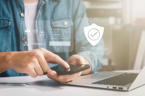 Cybersecurity internet and networking concept. Close up of hand holding smart Stock Photos
