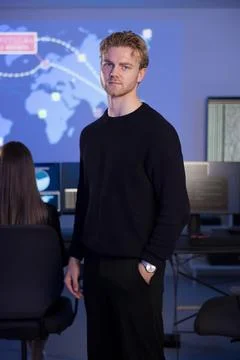 Cybersecurity professional in a technology control room monitoring global Stock Photos