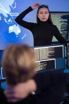 Cybersecurity professionals analyzing real-time threats in a high-tech Stock Photos