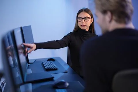 Cybersecurity professionals discussing and analyzing network security data on Stock Photos
