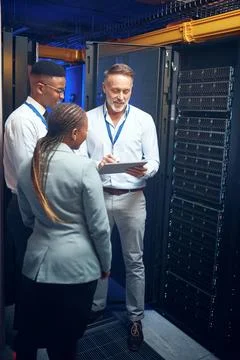 Cybersecurity, storage and tablet with people in server room together for Stock Photos