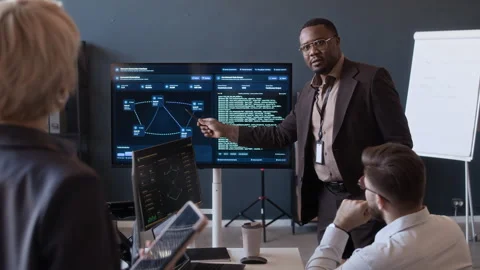 Cybersecurity Team Analyzing Network Data while Meeting in Office Stock Footage 334932035