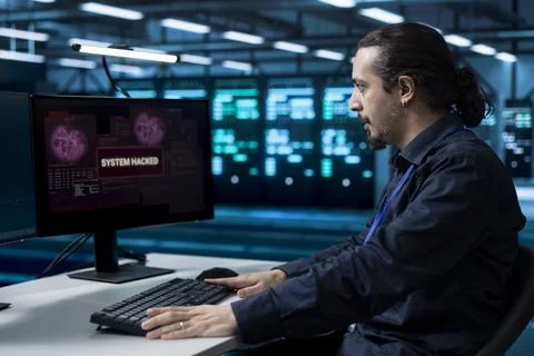 Cybersecurity, technician and hacking of compromised system Stock Photos