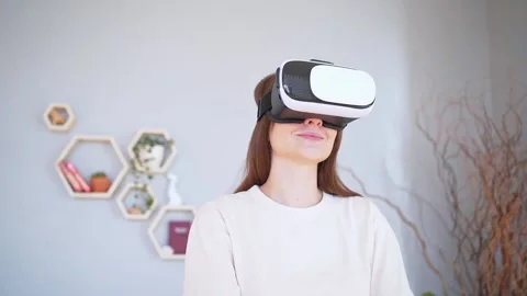 Cyberspace inside the house. Modern young woman in white virtual reality helmet Stock Footage 150029659