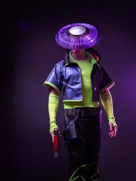 Cyborg killer in an Asian hat, a futuristic character with a gun in his hands. Stock Photos