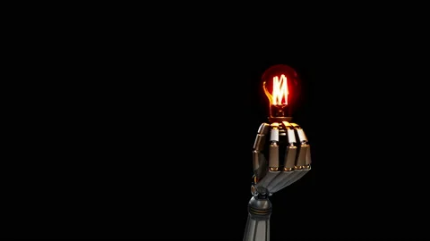 Cyborg robotic hand gives light bulb to viewer. 動画素材 99490154