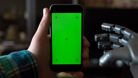 Cyborg uses the phone. Gray mechanical hand swipe down on smartphone with green Stock Footage 126862561