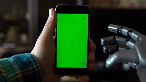 Cyborg uses the phone. Gray mechanical hand swipe left on smartphone with green Stock Footage 126862844