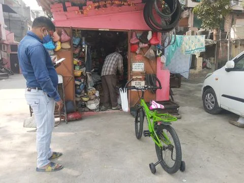 Cycle mechanic do repairing work at his roadside shop Stock Photos
