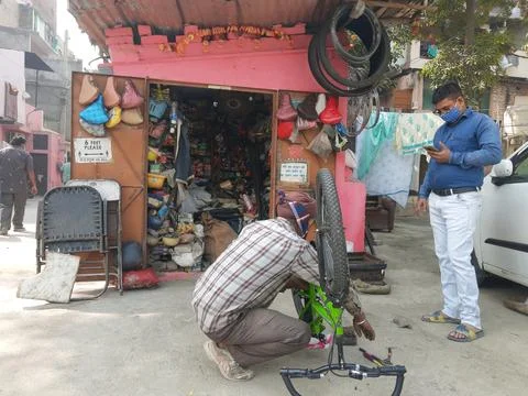 Cycle mechanic do repairing work at his roadside shop Stock Photos