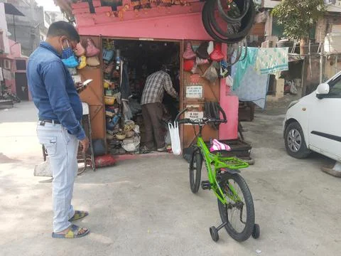 Cycle mechanic do repairing work at his roadside shop Stock Photos
