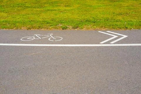 Cycle path in the park with direction indication Stock Photos