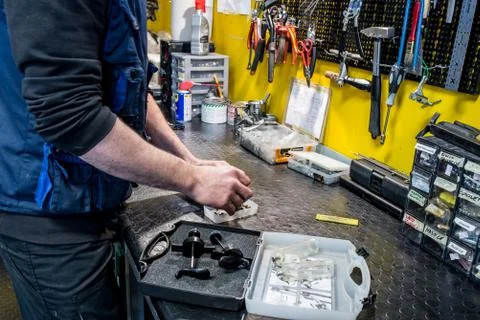 Cycle shop, workshop area with mechanical tools and parts, mechanician at wor Stock Photos