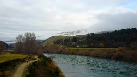 Cycle trail along blue river in New Zealand Stock Footage 94239766