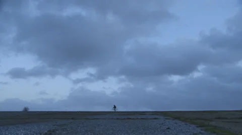 Cycling across horizon Stock Footage