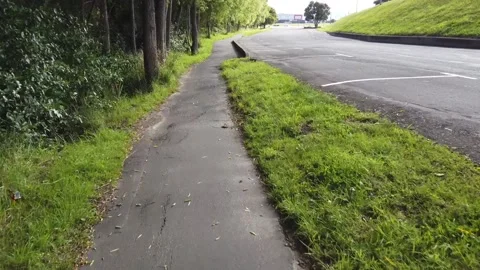 Cycling Along A Path By A Carpark Stock Footage 159674782