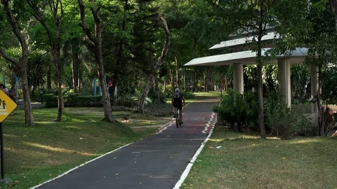 Cycling at Benjakitti Park, Bangkok Stock Footage