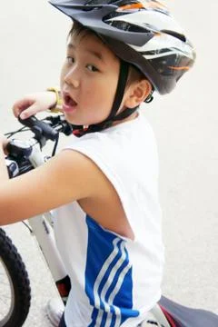 Cycling boy looking back Stock Photos