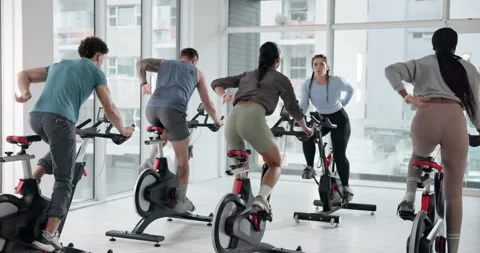 Cycling class, instructor and people in gym for fitness, workout or body Stock Footage 311077583