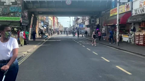 Cycling down peckham rye road since pedestrianisation Stock Footage 139349644
