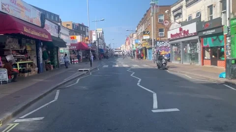 Cycling down peckham rye road since pedestrianisation Stock Footage 139349669