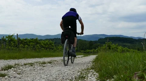 Cycling downhill - back view Stock Footage 63755412