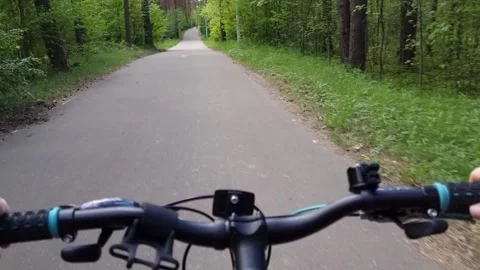 Cycling on a forest road. The video is in the first person, you can see the Stock Footage 309300249