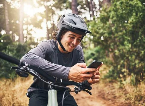 Cycling man in forest, phone gps and map direction with adventure, nature trail Stock Photos