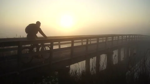 Cycling over the bridge Stock Footage 132982936