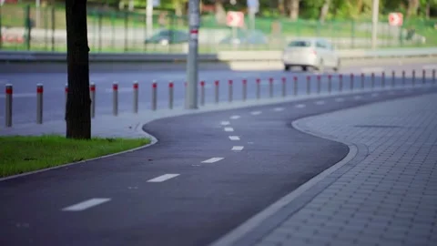 Cycling path separated from traffic in urban area. Promoting safe transport. Stock Footage 306623679