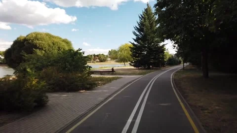 Cycling path through peaceful park landscape Stock Footage 330138587