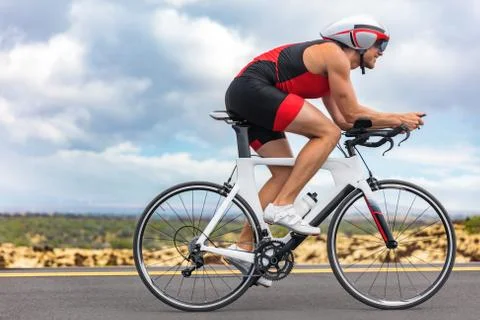 Cycling sport athlete man biking on triathlon bike. Fit male cyclist on Stock Photos